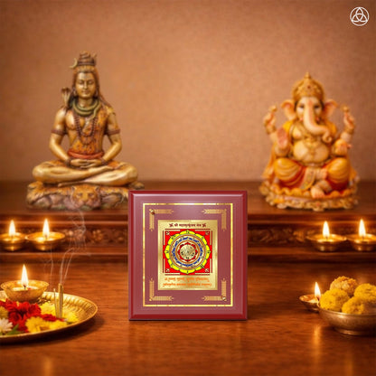Maha Mrityunjay Yantra displayed in a decorative frame on a wooden table, symbolizing planetary energies.