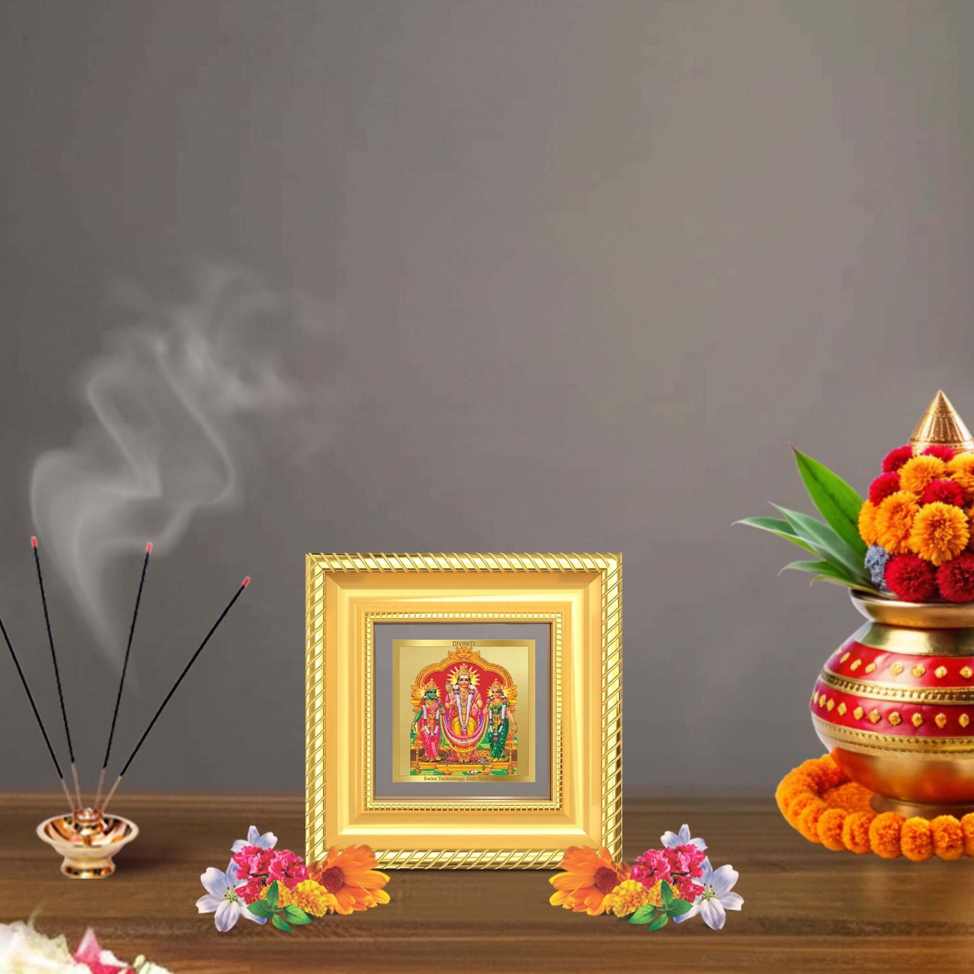 Lord Murugan with Valli | Divine Union Tabletop Frame in 24K Gold Plated Foil displayed with floral arrangements.