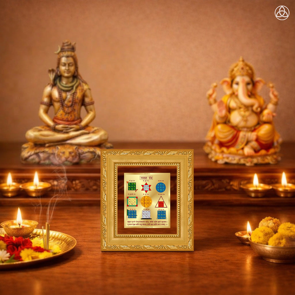 Navagraha Yantra displayed on a decorated altar with candles and idols of Hindu deities for spiritual harmony.