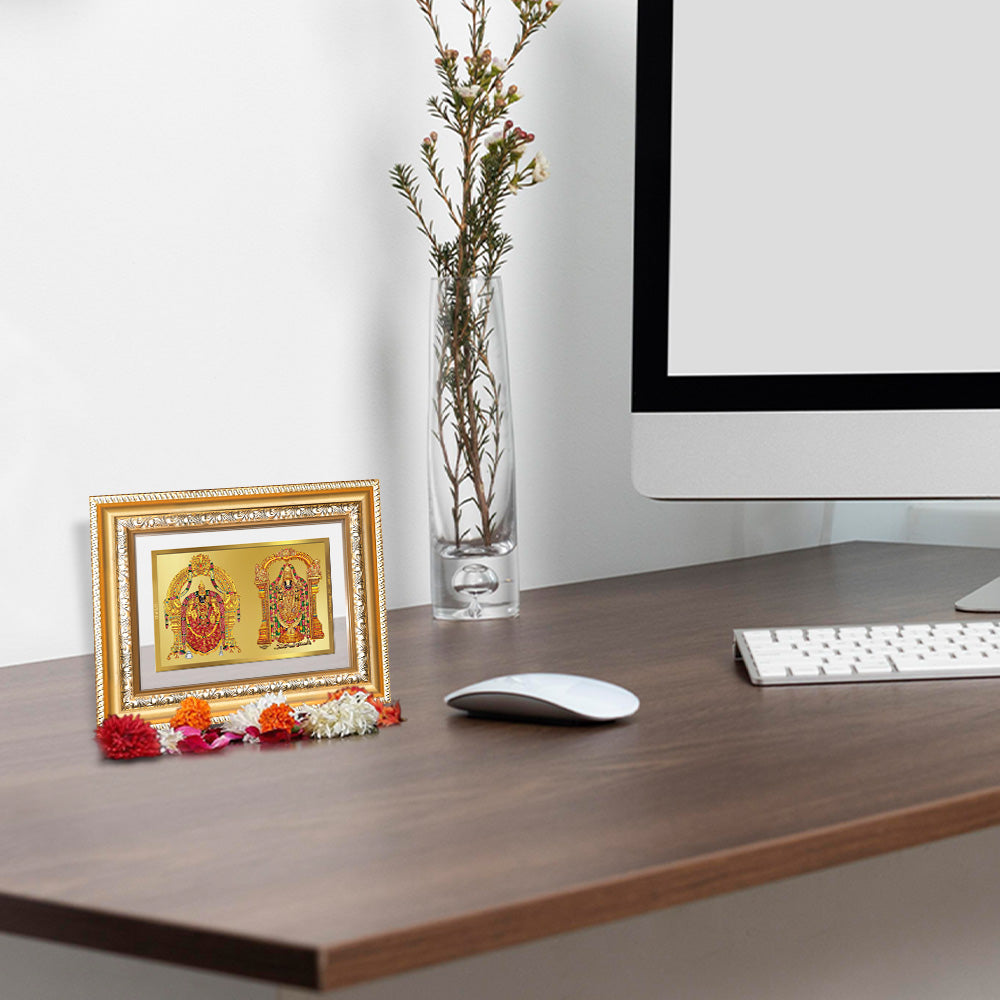 Lord Venkateswara Tirupati Balaji & Goddess Padmavati 24K gold-plated foil photo frame on a wooden tabletop.