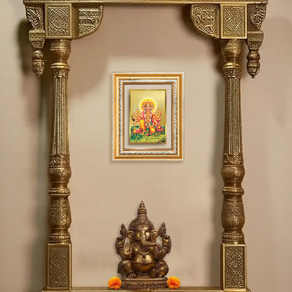 Panchmukhi Hanuman wall frame displayed in an ornate alcove with a statue of Ganesh below.