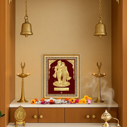 Radha Krishna wall hanging in gold frame, showcasing divine love in a serene temple setting.