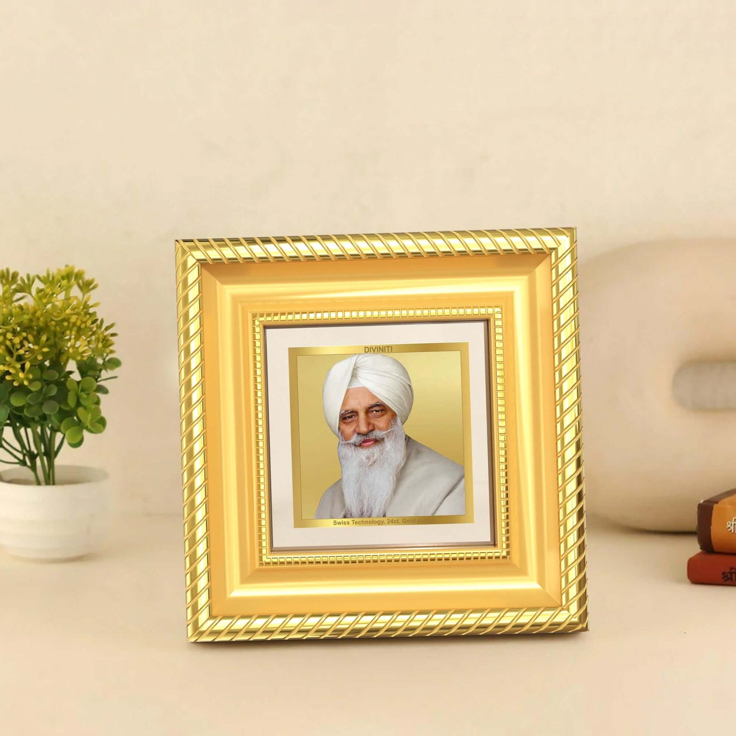 Baba Gurinder Singh Ji Maharaj in 24k gold plated foil displayed on table