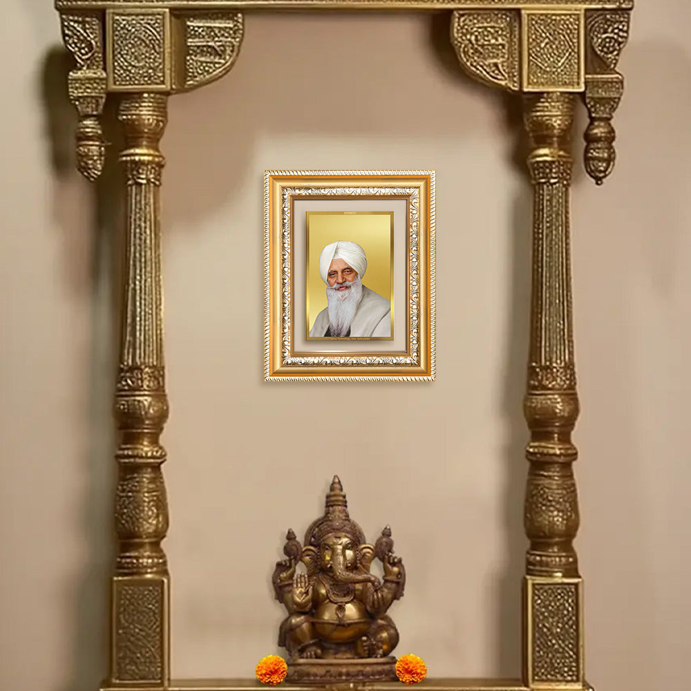 Baba Gurinder Singh Ji wall photo frame in a decorative golden shrine with Lord Ganesha statue.