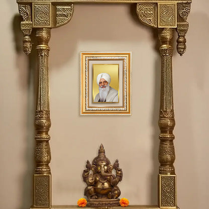 Baba Gurinder Singh Ji wall photo frame in a decorative golden shrine with Lord Ganesha statue.