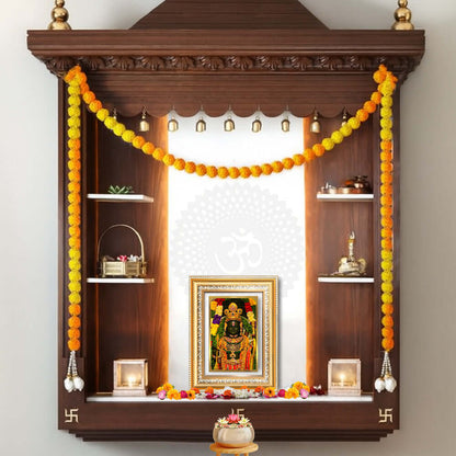 Ram Lalla framed photo in a beautifully decorated wooden altar with flowers and spiritual items.