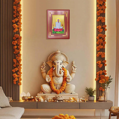 Saint Ram Thakur Photo Frame showcased between ornate pillars above a Lord Ganesha idol in a serene traditional temple interior