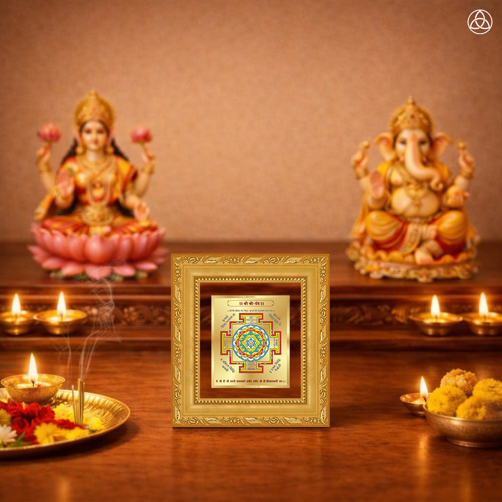 Shree Yantra displayed on a decorated altar with candles and idols of Hindu deities for spiritual harmony.