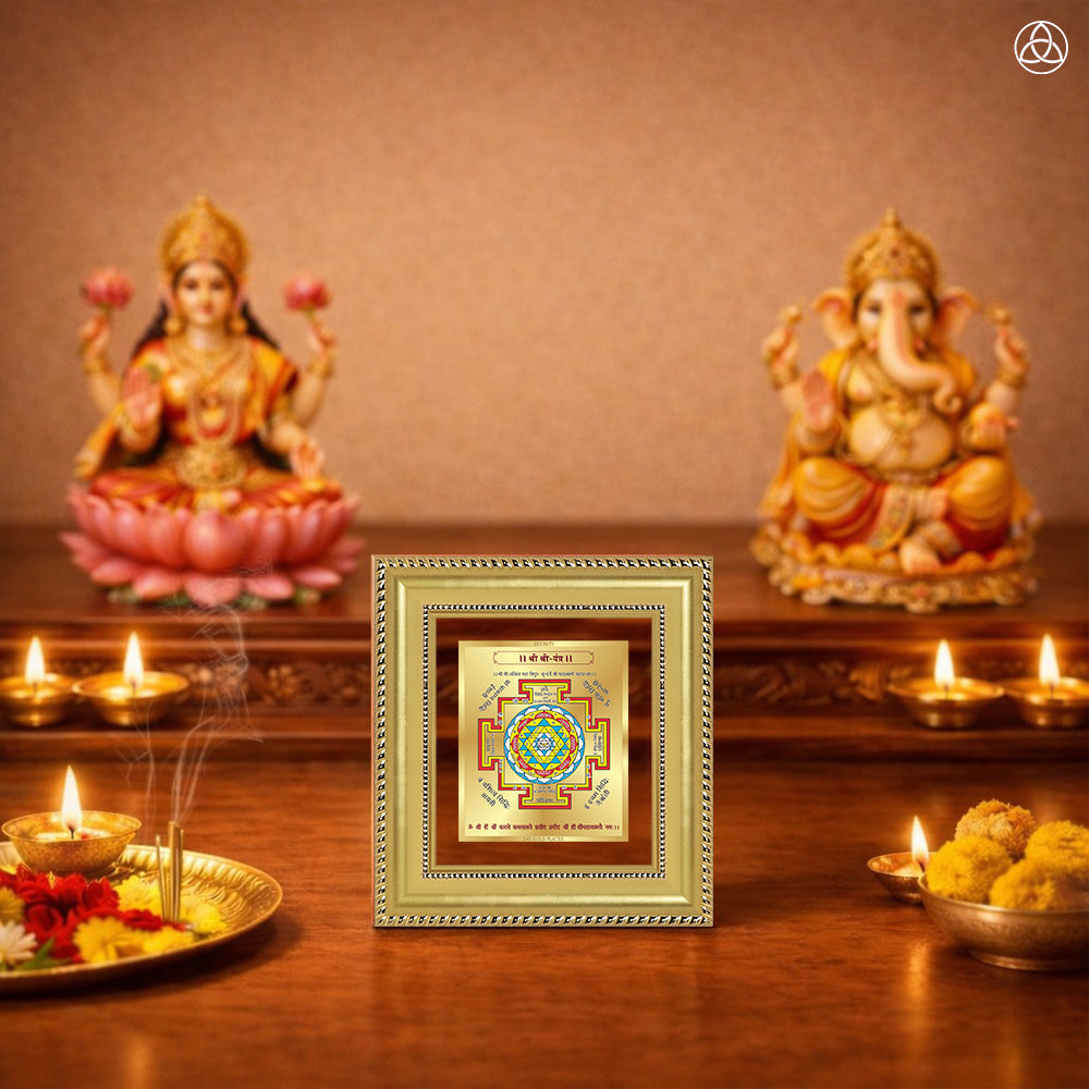 Shree Yantra displayed on a decorated altar with candles and idols of Hindu deities for spiritual harmony.