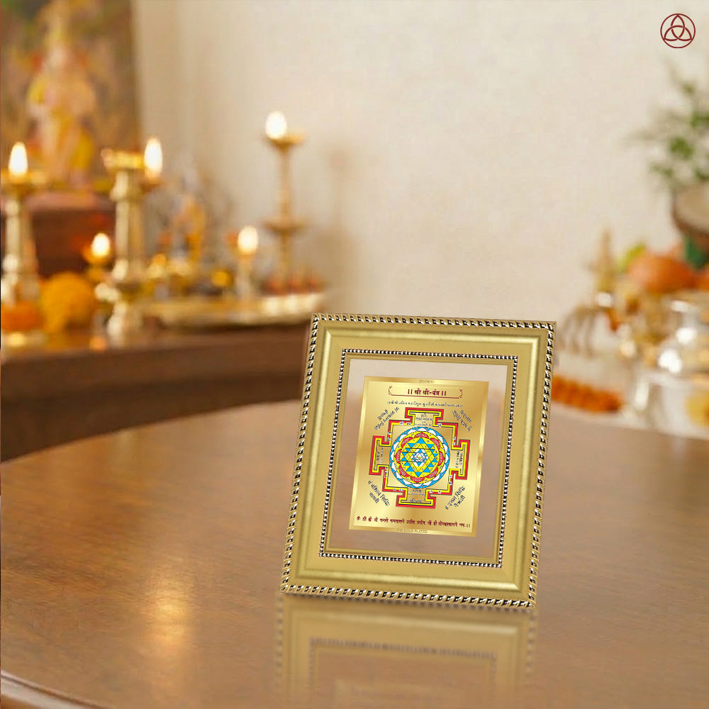Shree Yantra displayed in a decorative frame on a wooden table, symbolizing planetary energies.