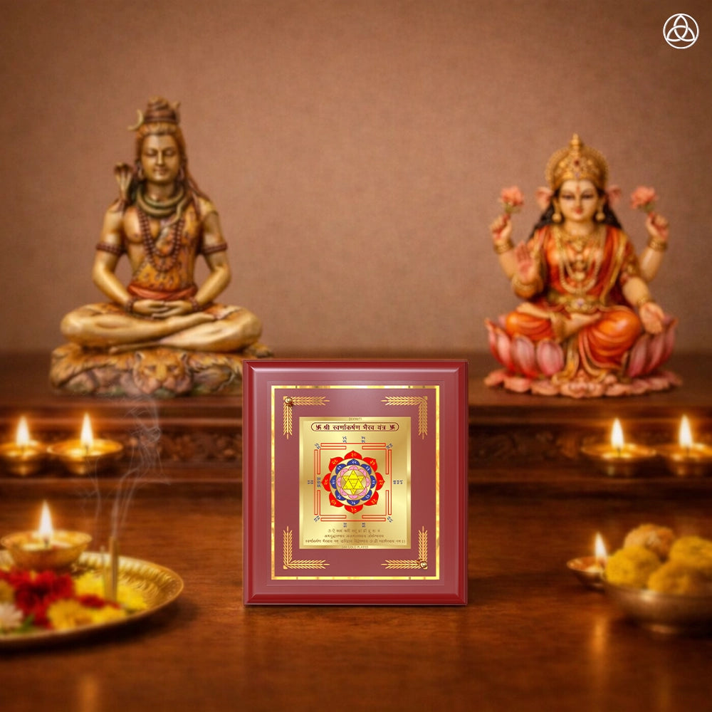 Swarn Akarshan Yantra displayed in a decorative frame on a wooden table, symbolizing planetary energies.