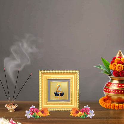 Sai Baba On Rock Tabletop Frame in 24K Gold Plated Foil displayed in a beautifully decorated wooden wall shrine.