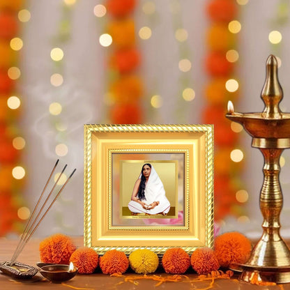 Holy Mother Sarada Devi Tabletop Frame in 24K Gold Plated Foil in a beautifully designed wall and tabletop photo frame, adorned with vibrant marigold flowers.