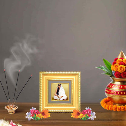 Holy Mother Sarada Devi Tabletop Frame in 24K Gold Plated Foil displayed in a beautifully decorated wooden wall shrine