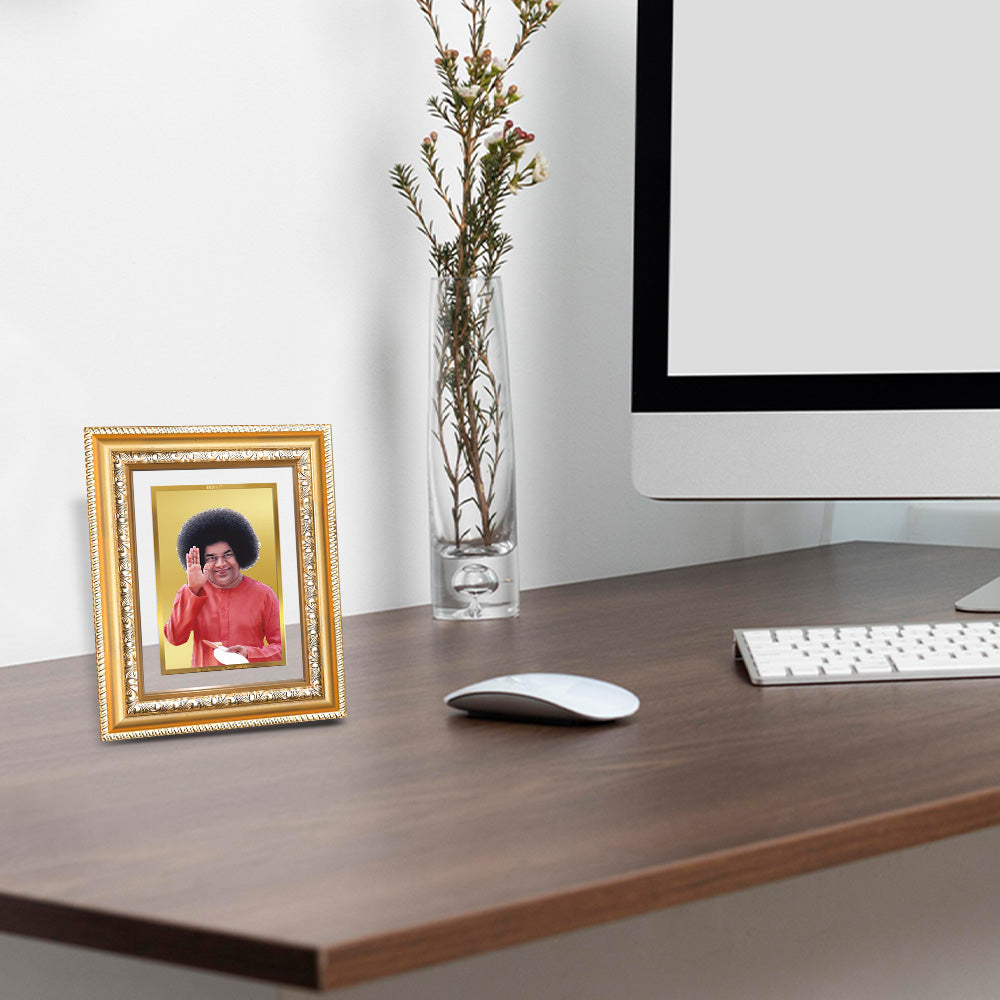 Sathya Sai Baba Tabletop Photo Frame in 24K Gold Plated Foil displayed at wooden table