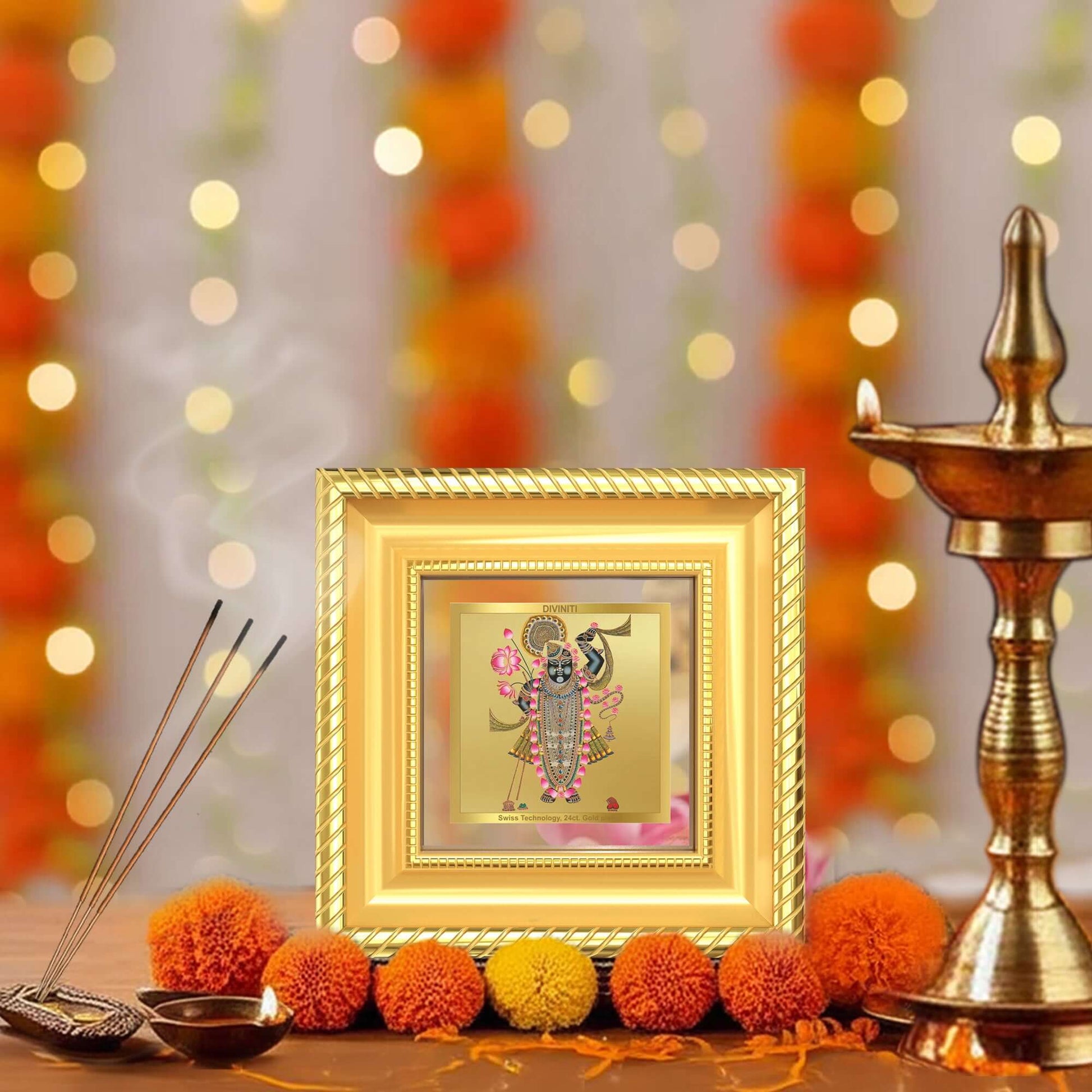 Lord Shrinathji Photo Frame in 24k gold plated foil displayed in a beautifully designed wall and tabletop photo frame, adorned with vibrant marigold flowers