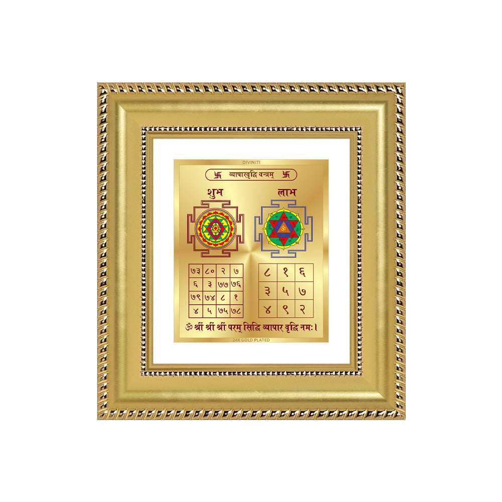 Vyapar Vriddhi Yantra displayed in a golden frame on a wooden table, surrounded by traditional decor.