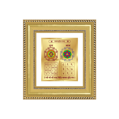Vyapar Vriddhi Yantra displayed in a golden frame on a wooden table, surrounded by traditional decor.