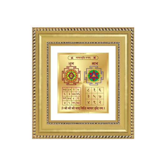 Vyapar Vriddhi Yantra displayed in a golden frame on a wooden table, surrounded by traditional decor.