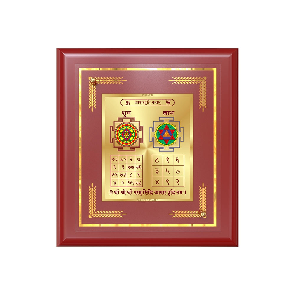 Vyapar Vriddhi Yantra displayed in a golden frame on a wooden table, surrounded by traditional decor.