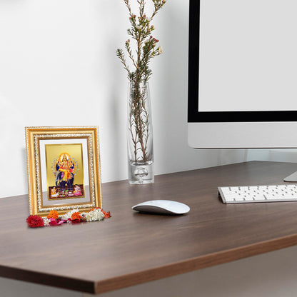 Lord Vishwakarma photo frame in 24k gold plated foil displayed on wooden table