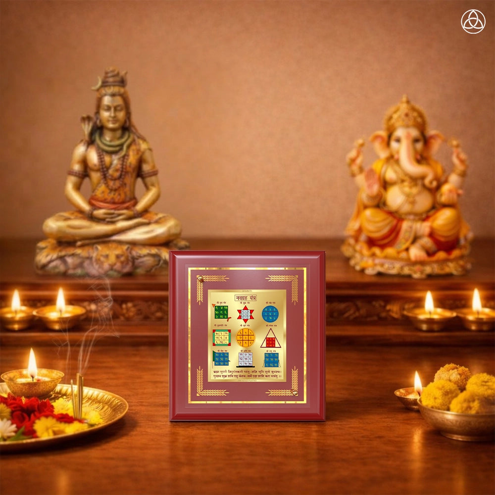 Navagraha Yantra displayed in a decorative frame on a wooden table, symbolizing planetary energies.
